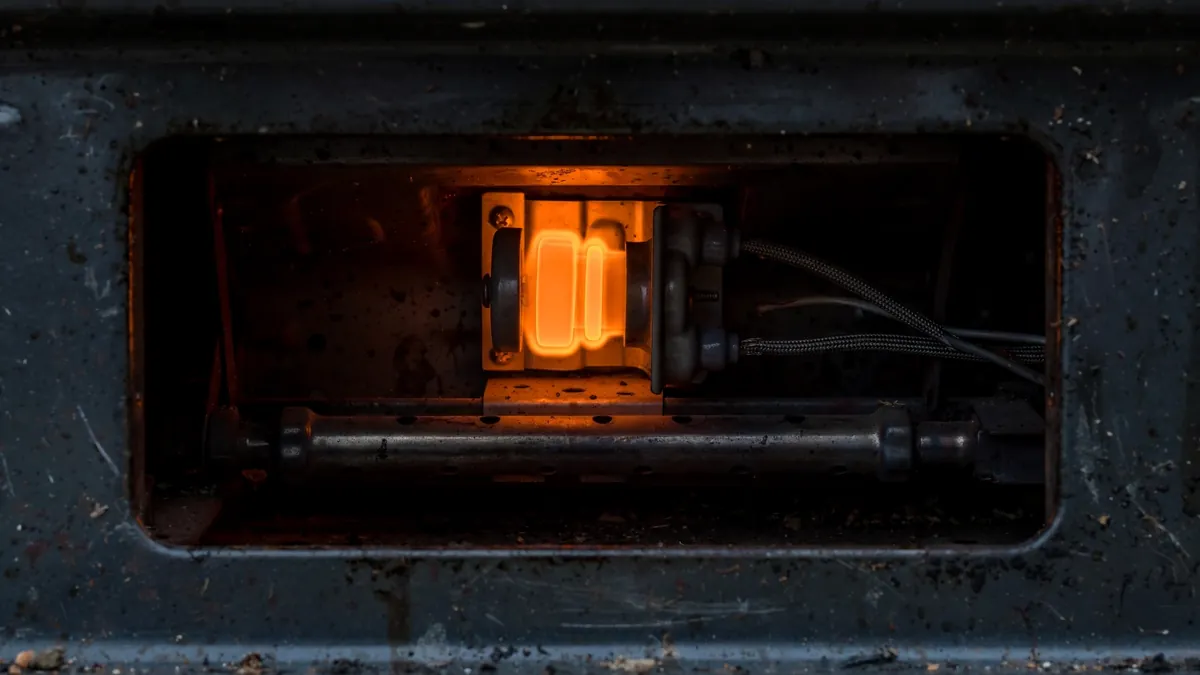 Gas oven igniter glowing orange with no flame, the classic sign of a weak igniter